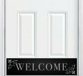 White door with a black 'WELCOME' kick plate featuring decorative elements.