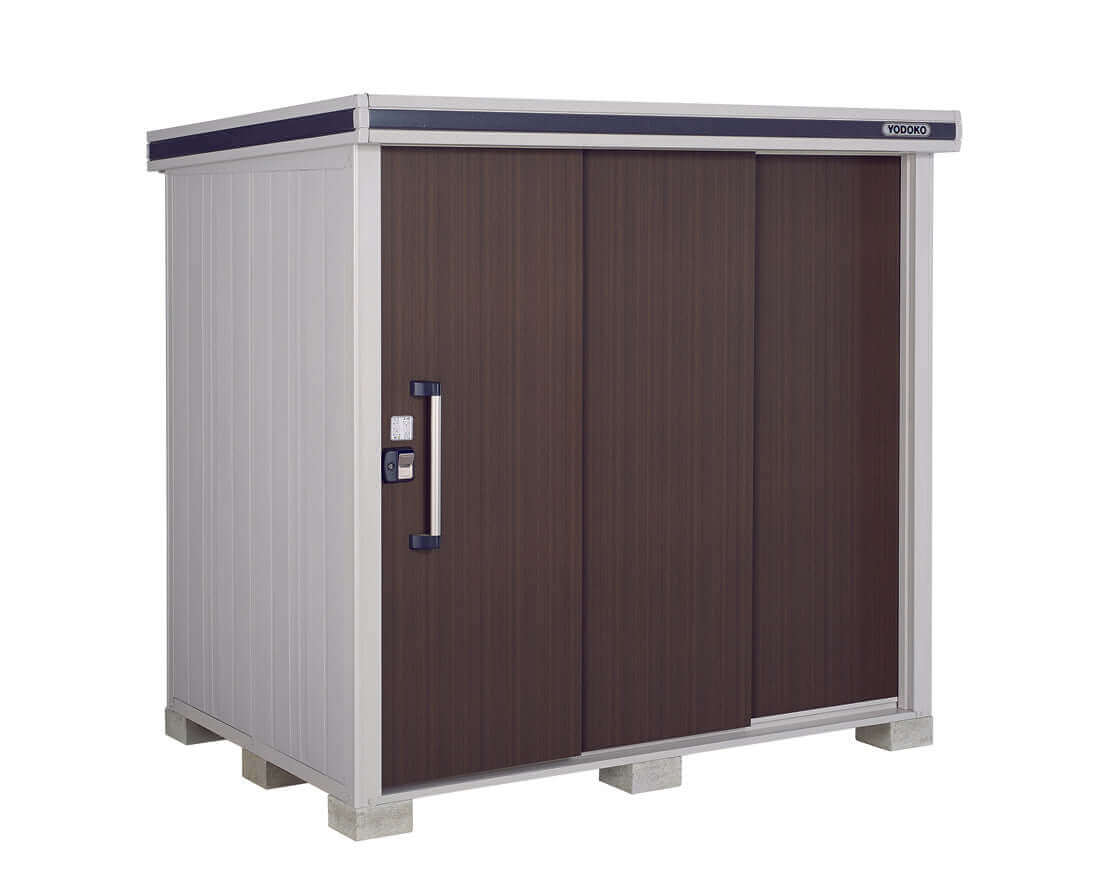 The YODOKO Premium Outdoor Large Shed LMDS by BON PERGOLA features wood grain walls, a dark brown sliding door with Japanese craftsmanship, light gray walls, and a flat roof. Elevated on concrete blocks, it has a modern design with a handle and small lock for security.