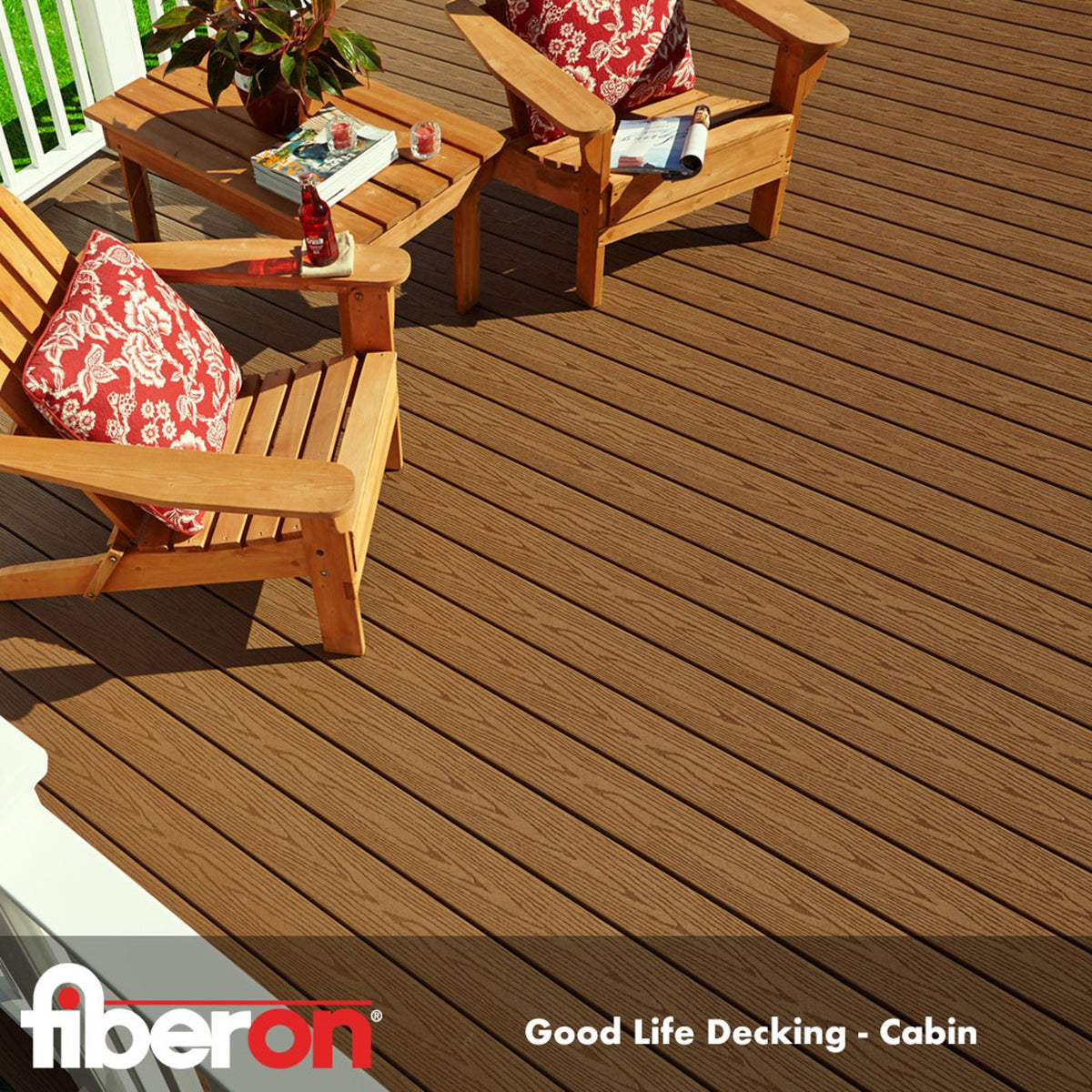 Fiberon A outdoor decking area featuring brown composite capped decking with wooden chairs and a table, accompanied by red cushions.