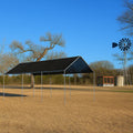 Black 10' x 20' mesh tarp canopy serving as a recreational beach shelter