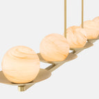 Minka-Lavery Olenne 64 in. 5-Light Linear Chandelier, Legacy Brass with Etched Amber Swirl Glass